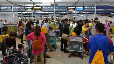 Air traveler queue at departure counter flight check for Flight Cancellations